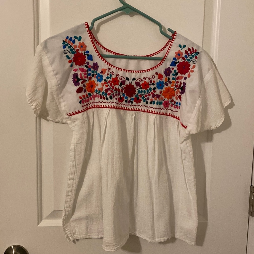 White flowy blouse with fun floral detail
